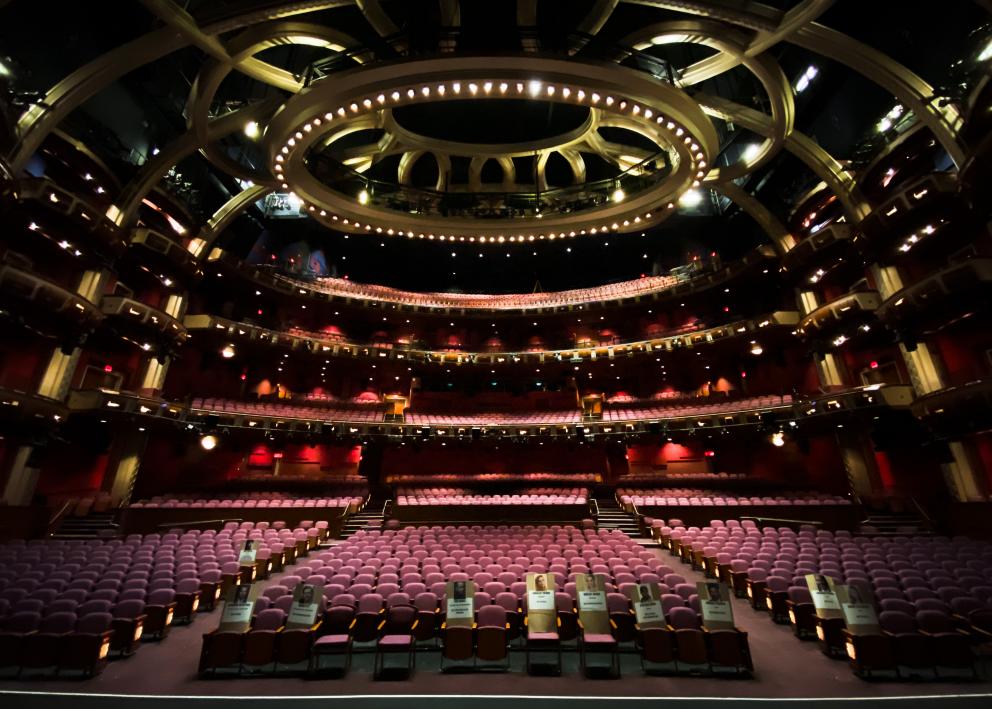 A view from the stage looking into an empty theatre auditorium